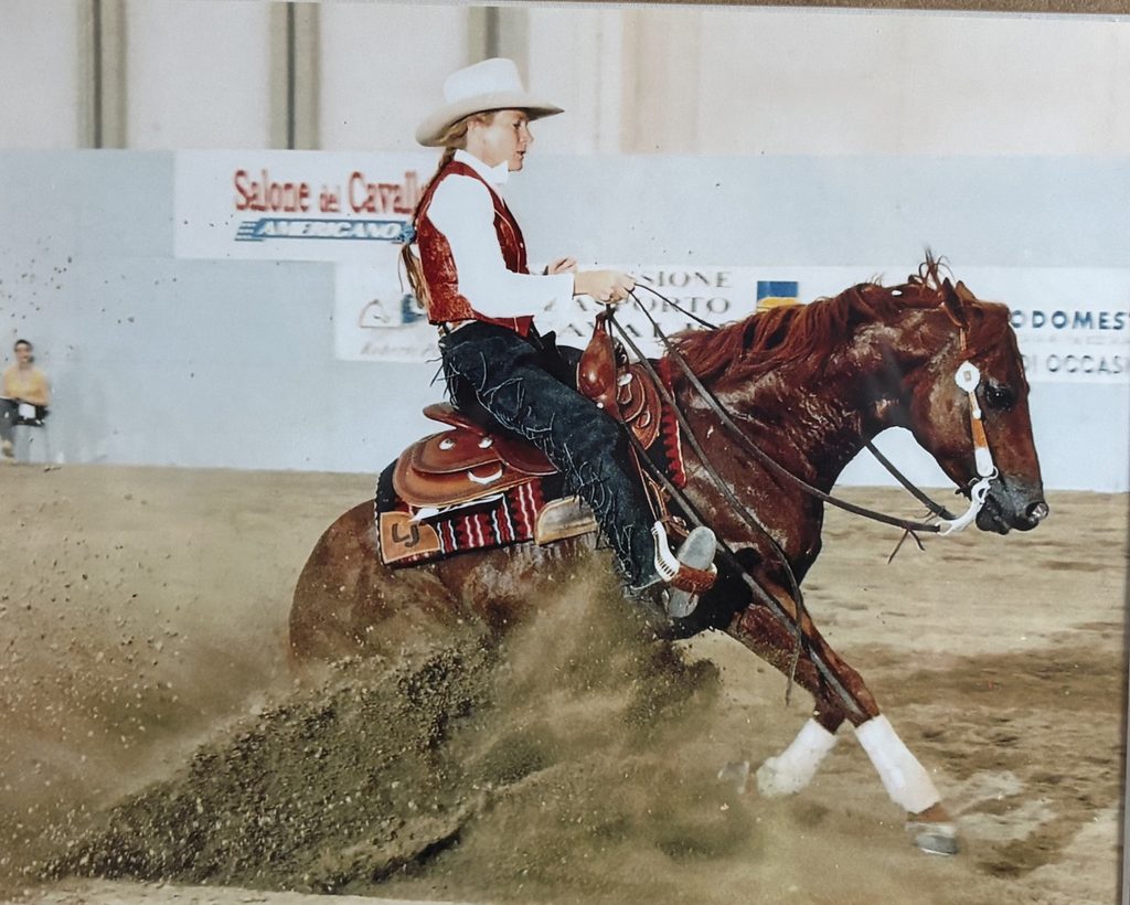 Jan Dublin riding a sorrel reining horse through a sliding stop
